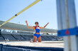 © Trevor Adeline/Caia Image - Portrait happy female track and field athlete at high jump