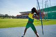 © Trevor Adeline/Caia Image - Female track and field athlete throwing javelin
