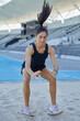 © Trevor Adeline/Caia Image - Female track and field athlete long jumping