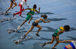 © Trevor Adeline/Caia Image - Female track and field athletes taking off from starting blocks