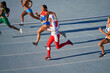 © Trevor Adeline/Caia Image - Female track and field athletes running in competition on sunny track