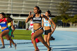 © Trevor Adeline/Caia Image - Female track and field athletes running in competition on race track