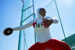 © Trevor Adeline/Caia Image - Determined female track and field athlete in hijab throwing discus