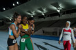 © Trevor Adeline/Caia Image - Happy female track and field athletes celebrating on track at night