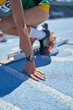 © Trevor Adeline/Caia Image - Close up female track and field athlete at starting block