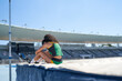 © Trevor Adeline/Caia Image - Female track and field high jumper in sunny stadium