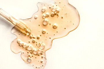 Sticker - yellow texture of a drop of whey or olive oil on a white background. transparent sample of cosmetic 