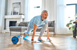 © Valerii Apetroaiei - Sport, fitness and healthy lifestyle concept. Mature man doing exercises at home. How to stay healthy on quarantine concept.