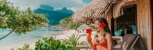 Woman Drinking Tropical Fruits Juice Morning Breakfast At Hotel Room Balcony On Beach. Vacation Travel In Bora Bora, French Polynesia Landscape Banner Panoramic. Happy Tourist Enjoying Summer Holiday.