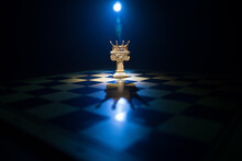 Chess Board Game Concept Of Business Ideas And Competition And Strategy Ideas Concep. Chess Figures On A Dark Background With Smoke And Fog And Window With Sunlight. Selective Focus