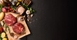 © amenic181 - Fresh raw pieces of beef meat with ingredients for cooking on panorama black stone background