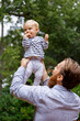 © Tetra Images - Father holding baby girl in air, outdoors
