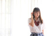 © Oran Tantapakul - Portrait japanese school girl uniform in white tone bed room