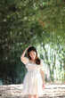 © Oran Tantapakul - Beautiful young woman with white dress on bamboo forest background