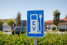 A View Of A City Sign And Symbol For Electric Vehicle Parking And Charging.