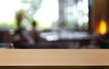 Empty wooden table in front of abstract blurred background of coffee shop . can be used for display or montage your products.Mock up for display of product