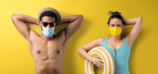 Wall Mural - Flat lay top view portrait of young couple with face mask, summer holiday, coronavirus and travel concept.