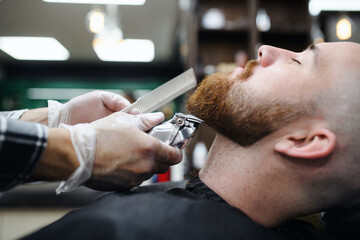 Wall Mural - Young man client visiting haidresser in barber shop, midsection and close-up.