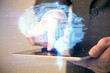 © peshkova - Double exposure of man's hand holding and using a digital device and brain hologram drawing. Data concept.