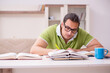 © Elnur - Young male student preparing for exams at home