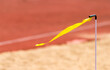 Yellow wind flag on track and field stadium background. Long jump and triple jump sport concept