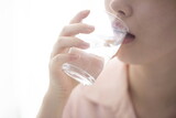 Fototapeta Łazienka - Woman drinking water from glass,close up
