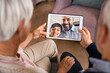 © Rido - Family doing video call using digital tablet at home