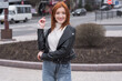 © Павел Костенко - Portrait of a beautiful and positive redhead woman with clothes in grunge style. Posing while walking