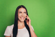 © Tetiana - Photo of brunette lady with telephone talking best friend isolated green background