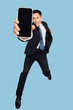 © Tom Wang - Excited Young business man dancing and showing the  mobile phone screen