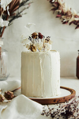 Sticker - Closeup shot of delicious Boho ombre cake with dry flowers on a white table