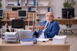© Elnur - Old businessman employee after accident working in the office