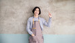 © paulaphoto - Startup successful small business owner man point up in coffee shop restaurant with copy space. Portrait of young asian man successful barista cafe local owner seller sme service job, unisex concept