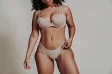 Body Acceptance Concept.  Curvy Girl Posing In Studio Against Society Prejudice