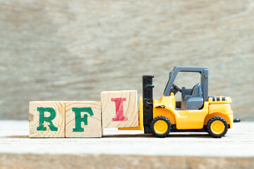 Sticker - Toy forklift hold letter block I to complete word  RFI (Abbreviation of request for information) on wood background