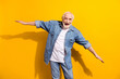 © deagreez - Portrait of attractive cheerful comic man having fun flying like plane isolated over vivid yellow color background
