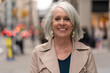 © blvdone - Mature caucasian woman in city smiling happy face portrait