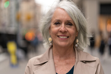 Poster - Mature caucasian woman in city smiling happy face portrait