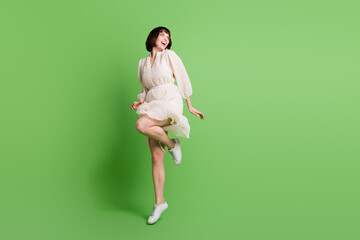 Poster - Full length body size photo woman wearing dotted dress jumping up looking copyspace dancing isolated pastel green color background