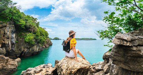 Wall Mural - Traveler woman on cliff joy amazed nature scenic landscape Ko Khao Yai, Adventure attraction outdoor place tourist travel Satun Thailand beach holiday vacation trip, Tourism beautiful destination Asia