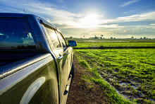Pickup Truck In The Field At Sunset