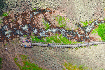 Wall Mural - Hikers on a hiking trail along a river