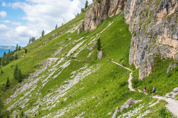 Wall Mural - hikers on a hiking trail in the alps mountains