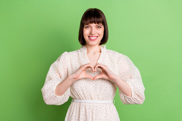 Sticker - Photo of young girl happy positive smile show fingers heart symbol love feeling romantic isolated over green color background