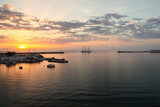Fototapeta Pomosty - Tourist ship entering the port at sunset