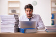 © Elnur - Young businessman employee unhappy with excessive work in the office