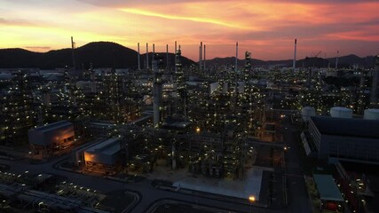 Wall Mural - Chemical oil refinery plant, power plant and metal pipe on sunset sky background.
