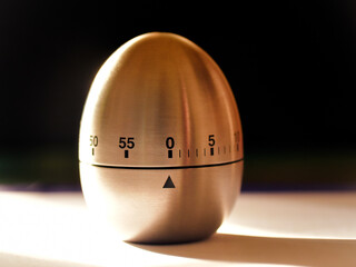 A mechanical Kitchen timer on a table