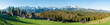 Full wide panorama of Tatra Mountains viewed from Głodówka glade in Poland with typical Polish highlander houses. Early morning in spring