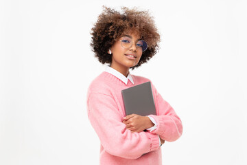 Fashion portrait of african american teen girl, high school or online course student holding laptop, isolated on gray background